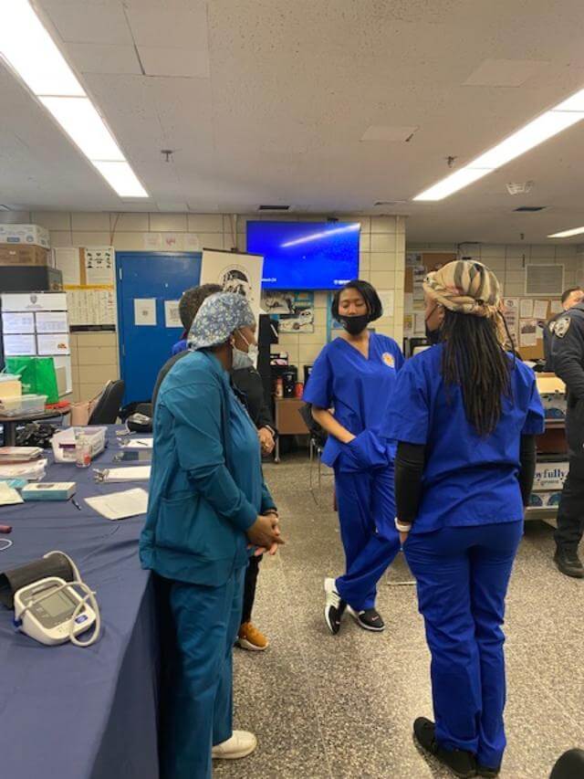 Nurses at a screening event in a station hall