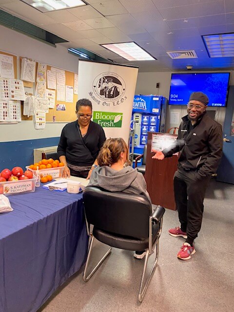 Volunteers at a screening table in a station room