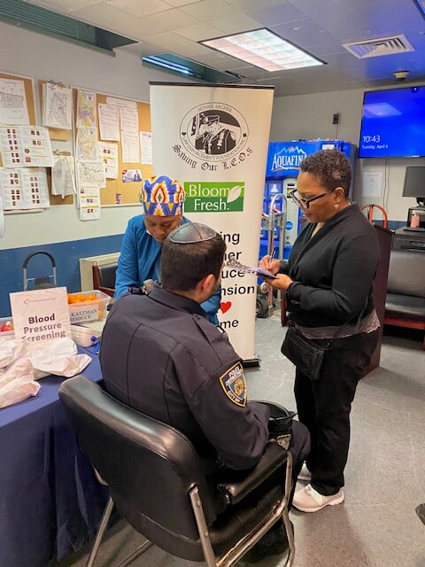 Volunteer screening a man in a station room