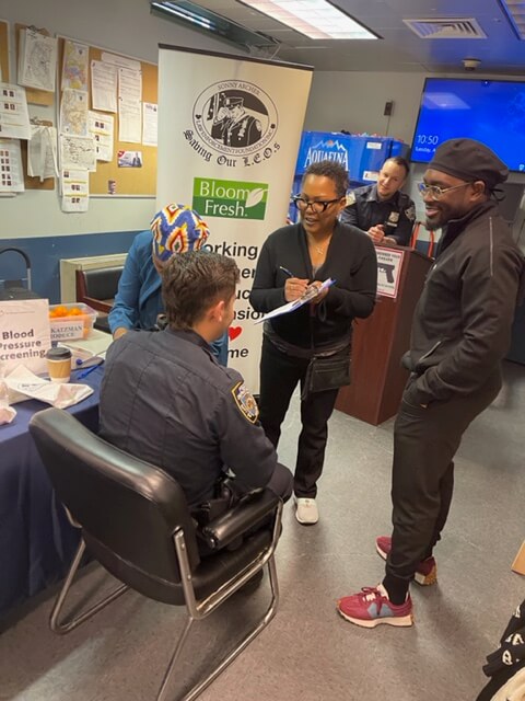 Visitors at a screening table in a station room