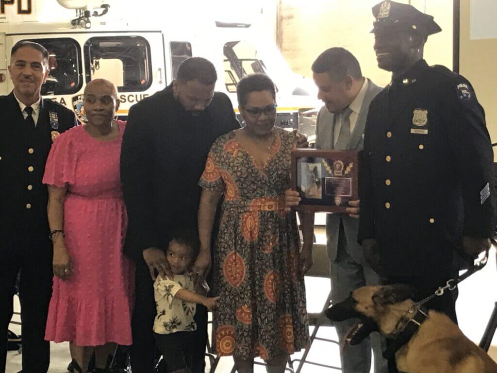 Police officers and guests with a K9 dog