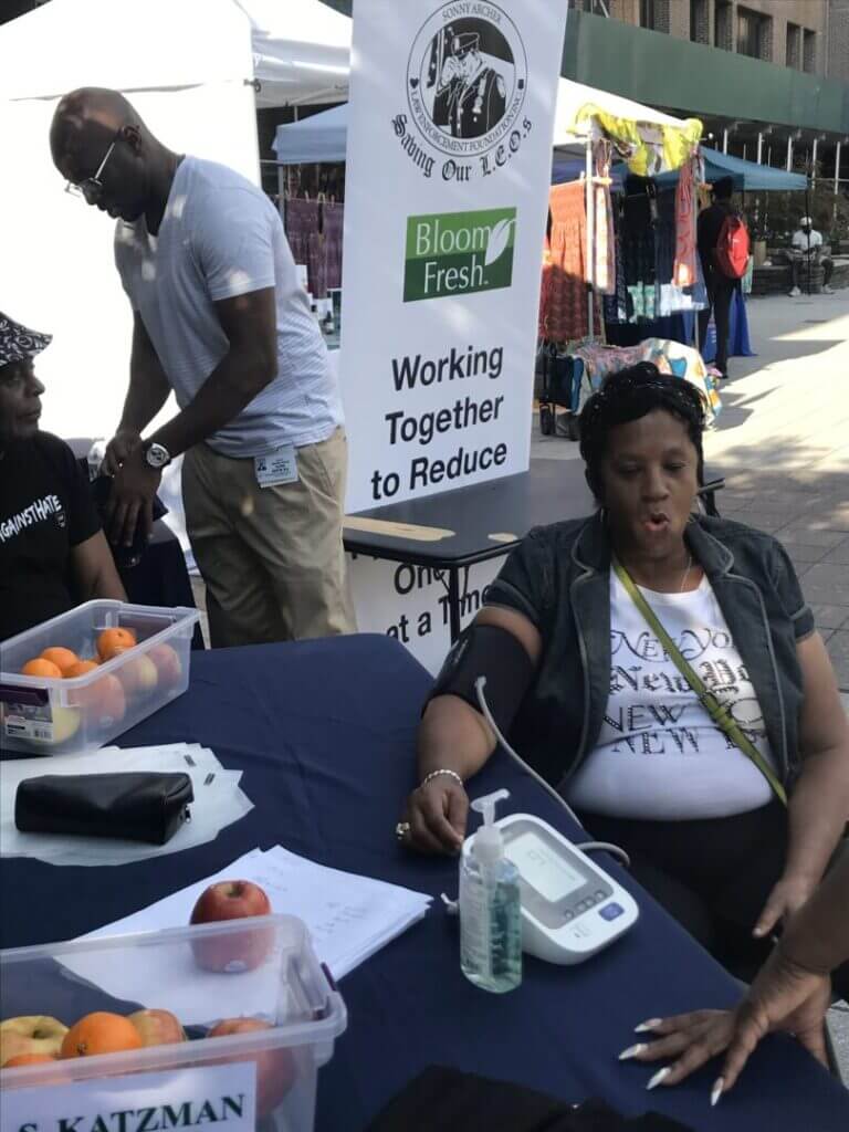 Woman having her blood pressure checked at an outdoor table