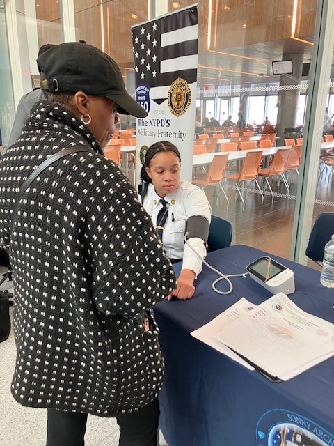Man in a cap having his blood pressure checked in a station
