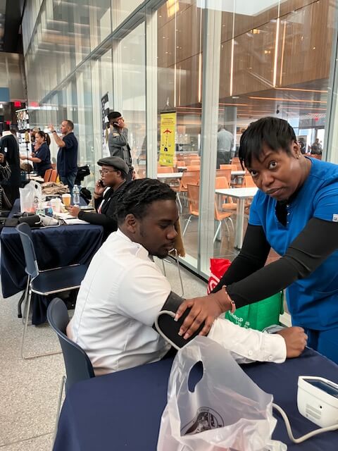Nurse screening a visitor at a table