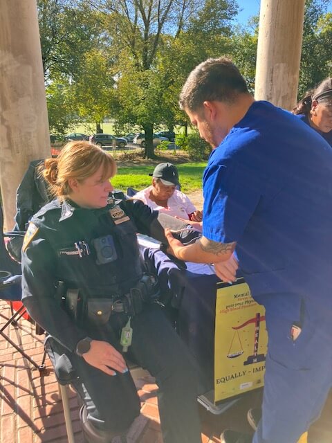 Volunteer screening an officer outdoors